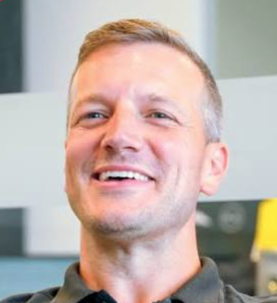 Portrait of co-founder Dave Ovcjak, laughing, photographed indoors