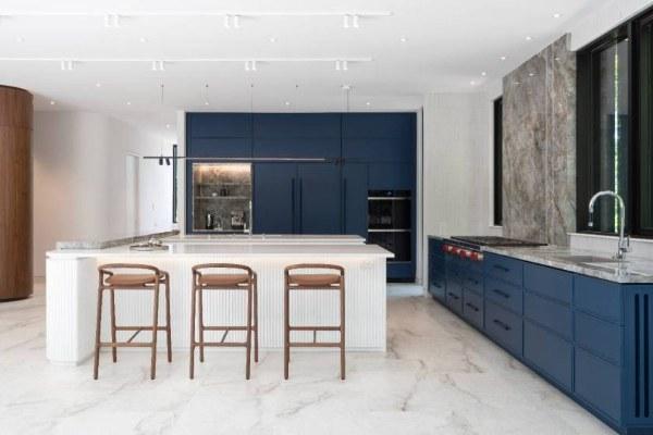 Kitchen with navy cabinetry and a quartzite slab