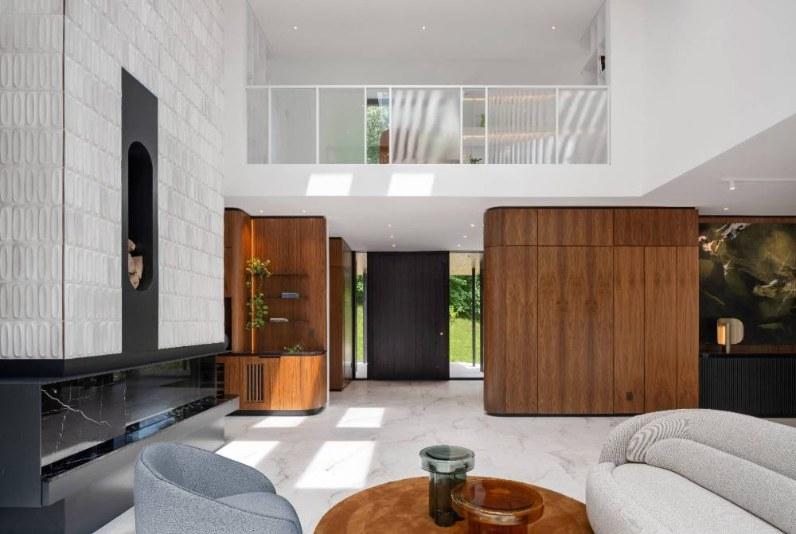 Living room of House in the Hill, textured white brick fireplace